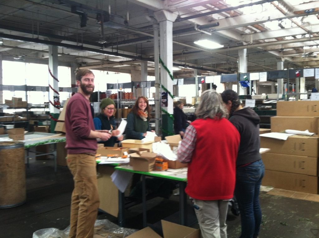 You know how our Tabletop Trees arrive fully decorated and strung with lights? Here, members of our staff pack up the batteries you'll need for the lights.